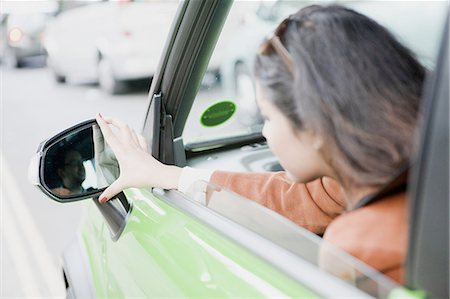 side mirror - Woman adjusting side mirrors Stock Photo - Premium Royalty-Free, Code: 649-06401140