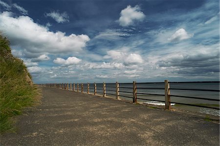 road not car not people - Wooden posts on paved coastal road Stock Photo - Premium Royalty-Free, Code: 649-06401164