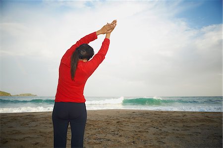 simsearch:649-06401179,k - Woman stretching on beach Stock Photo - Premium Royalty-Free, Code: 649-06401169