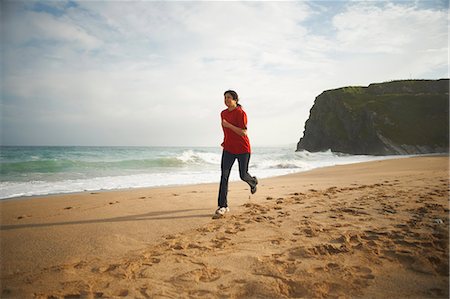 Woman running on beach Stock Photo - Premium Royalty-Free, Code: 649-06401170