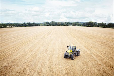 fields high view - Tractor driving in tilled crop field Stock Photo - Premium Royalty-Free, Code: 649-06401227