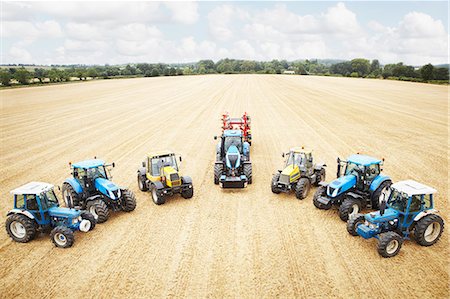 field of wheat with people - Tractors parked in tilled crop field Stock Photo - Premium Royalty-Free, Code: 649-06401221