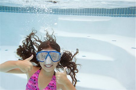 pool fun kids - Girl giving thumbs up underwater Stock Photo - Premium Royalty-Free, Code: 649-06401425