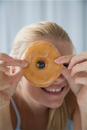 playing with food - Woman peering through donut hole Foto de stock - Sin royalties Premium, Código: 649-06432251