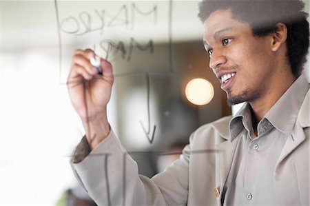 Businessman writing on window Stock Photo - Premium Royalty-Free, Code: 649-06432322