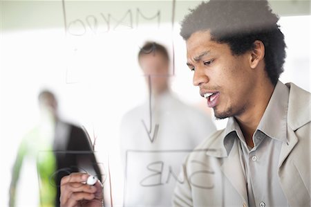 Businessman writing on window Stock Photo - Premium Royalty-Free, Code: 649-06432323