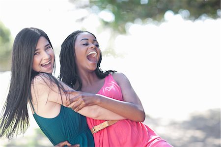 simsearch:649-06432371,k - Smiling women hugging outdoors Stock Photo - Premium Royalty-Free, Code: 649-06432334