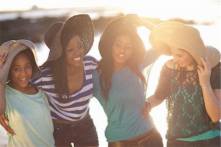 simsearch:6108-06906830,k - Women wearing sun hats on beach Stock Photo - Premium Royalty-Free, Code: 649-06432377