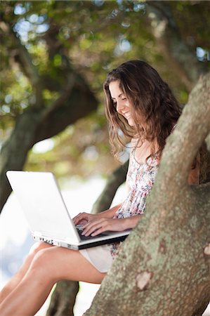 people sitting on branch tree - Woman using laptop in tree outdoors Stock Photo - Premium Royalty-Free, Code: 649-06432385