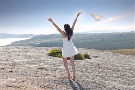 excited, arms up - Woman playing on rock formation Stock Photo - Premium Royalty-Free, Code: 649-06432418