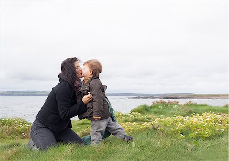 Mother and son kissing in grassy field Stock Photo - Premium Royalty-Free, Code: 649-06432454