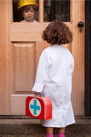 dressing up as a girl photos - Girl playing doctor making house call Stock Photo - Premium Royalty-Free, Code: 649-06432493