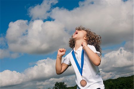 sport children - Girl with medal cheering outdoors Stock Photo - Premium Royalty-Free, Code: 649-06432507