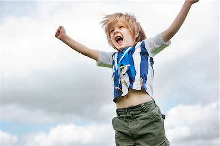 shout low angle - Boy with medals cheering outdoors Stock Photo - Premium Royalty-Free, Code: 649-06432508