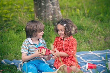 Girl giving gift at birthday picnic Foto de stock - Sin royalties Premium, Código: 649-06432514