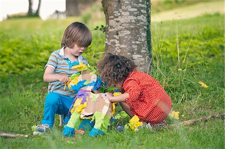 Children opening pinata at party Stock Photo - Premium Royalty-Free, Code: 649-06432525