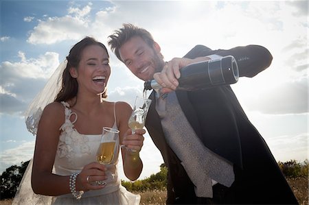 pouring - Couple de jeunes mariés ayant champagne Photographie de stock - Premium Libres de Droits, Code: 649-06432572