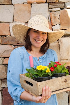 simsearch:649-06432667,k - Woman carrying wooden box of flowers Stock Photo - Premium Royalty-Free, Code: 649-06432656