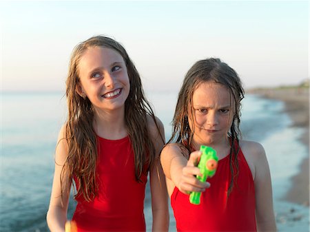 people pointing at a girl - Girls playing on beach together Stock Photo - Premium Royalty-Free, Code: 649-06432696