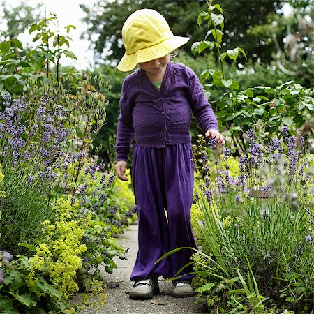 Girl walking in garden outdoors Stock Photo - Premium Royalty-Free, Code: 649-06432807