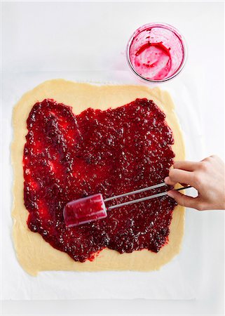 raspberries overhead - Hand spreading jam on dough Stock Photo - Premium Royalty-Free, Code: 649-06432835