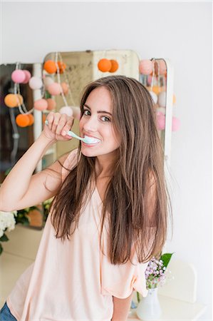 simsearch:6122-08229162,k - Smiling woman brushing her teeth Stock Photo - Premium Royalty-Free, Code: 649-06432889