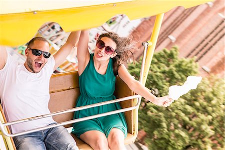 simsearch:649-06112676,k - Couple riding amusement park ride Stock Photo - Premium Royalty-Free, Code: 649-06432911