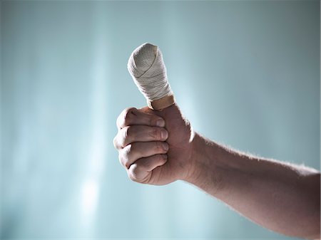 Close up of hand with bandaged thumb Stock Photo - Premium Royalty-Free, Code: 649-06432988