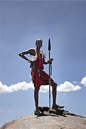 Maasai man standing on top of rock Stock Photo - Premium Royalty-Free, Code: 649-06433214