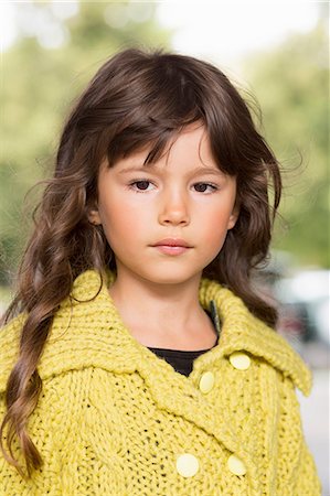 Girl wearing yellow sweater outdoors Stock Photo - Premium Royalty-Free, Code: 649-06433342