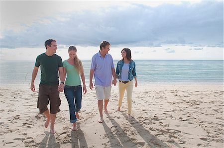 Couples holding hands on beach Stock Photo - Premium Royalty-Free, Code: 649-06433508