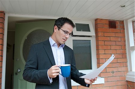 porch coffee - Businessman reading with cup of coffee Stock Photo - Premium Royalty-Free, Code: 649-06433530