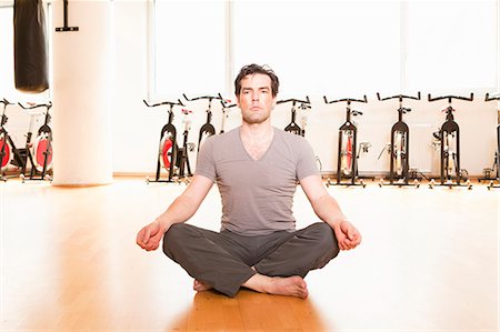 Man meditating on mat at gym Foto de stock - Sin royalties Premium, Código: 649-06433566