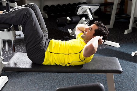 sitting up - Man using exercise equipment at gym Stock Photo - Premium Royalty-Free, Code: 649-06433560