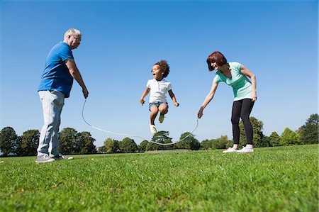 enthusiastic senior couple on amusement park - Older couple playing with granddaughter Stock Photo - Premium Royalty-Free, Code: 649-06433617