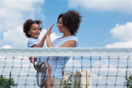 parent and child sports - Mother and daughter high fiving on court Stock Photo - Premium Royalty-Free, Code: 649-06433610