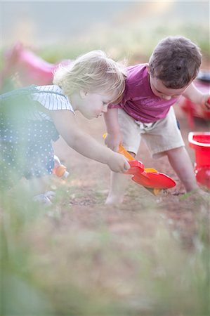 pá - Toddlers playing together on dirt road Foto de stock - Royalty Free Premium, Número: 649-06488449