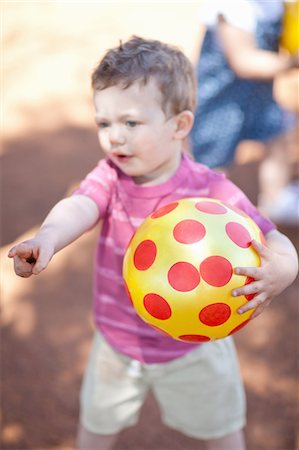 Toddler boy with ball on dirt road Stock Photo - Premium Royalty-Free, Code: 649-06488484