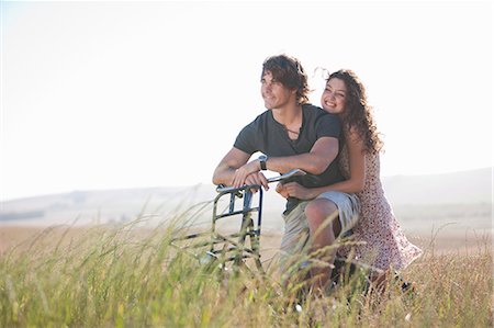 romantic rural couple - Couple riding bicycle in tall grass Photographie de stock - Premium Libres de Droits, Code: 649-06488578