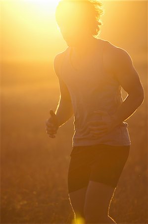 running - Man running in tall grass at sunset Stock Photo - Premium Royalty-Free, Code: 649-06488586
