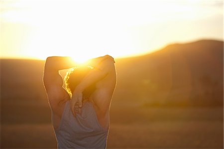 sun rise guy - Man stretching in field at sunset Stock Photo - Premium Royalty-Free, Code: 649-06488590