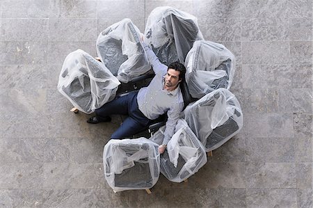 simsearch:649-06488802,k - Businessman sitting in new office chair Stock Photo - Premium Royalty-Free, Code: 649-06488779