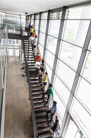 stairs with window - People passing boxes up stairs Stock Photo - Premium Royalty-Free, Code: 649-06488772