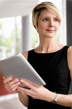 elegant business - Businesswoman holding tablet computer Photographie de stock - Premium Libres de Droits, Code: 649-06488817