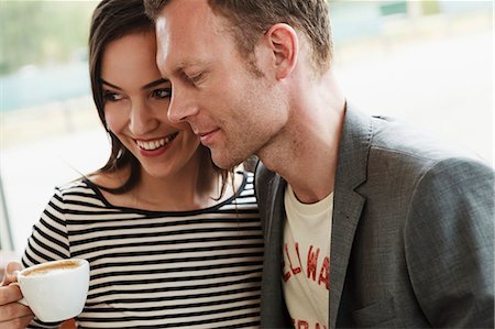 enjoying coffee together - Smiling couple hugging in cafe Stock Photo - Premium Royalty-Free, Code: 649-06488886