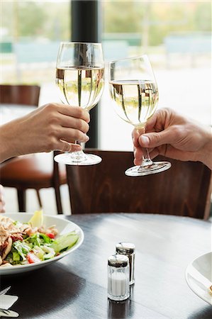 simsearch:6122-07701755,k - Couple toasting each other at cafe Stock Photo - Premium Royalty-Free, Code: 649-06488888