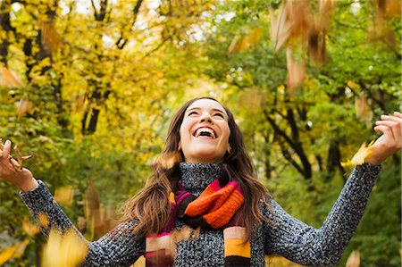 freedom and one adult - Woman playing in autumn leaves Stock Photo - Premium Royalty-Free, Code: 649-06488906