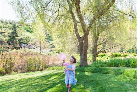 Girl playing with butterfly net in field Stock Photo - Premium Royalty-Free, Code: 649-06489015