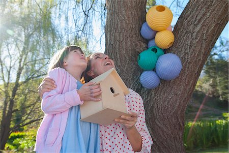 family hanging - Mother and daughter holding birdhouse Stock Photo - Premium Royalty-Free, Code: 649-06489029