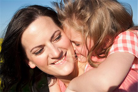 Mother and daughter hugging outdoors Stock Photo - Premium Royalty-Free, Code: 649-06489066